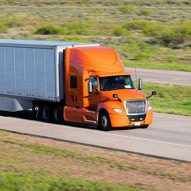 Freight Shipping from Utah to Texas - Orange truck on road - Truckload service
