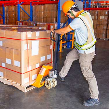 Shipping from Alaska to California - Worker lifting boxes on pallet
