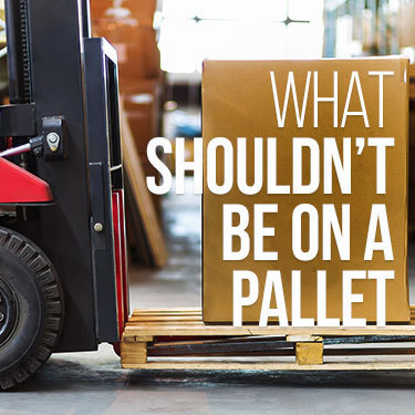 Forklift lifting a pallet with a box on it slightly above the ground