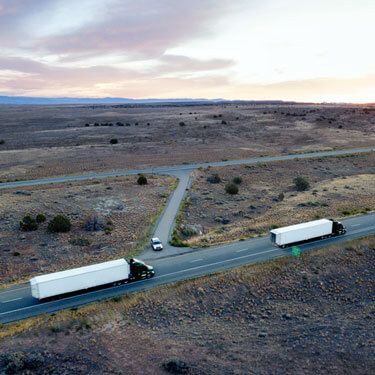Freight Shipping from Georgia to Texas - Trucks on road in arid terrain