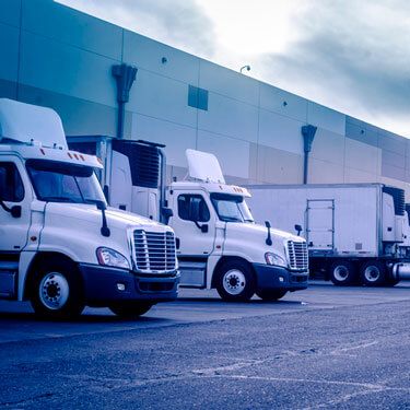 Shipping from South Carolina to California - Trucks parked at a facility