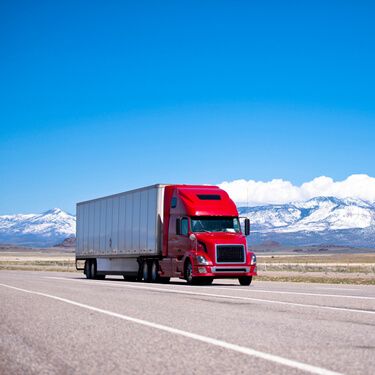 Freight Shipping from Utah to California - Red semi truck on highway near mountains